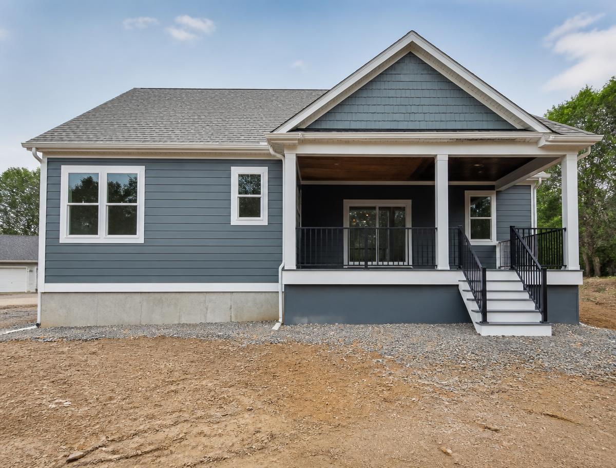 Rear exterior of a new construction home with painted porch columns and white trim